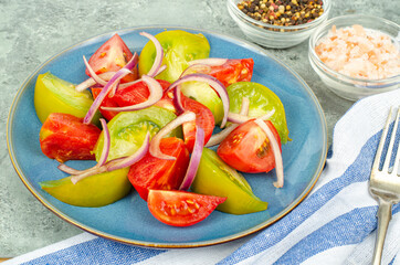 Wall Mural - Diet food. Salad of slices of fresh bright tomatoes and onions. Studio Photo