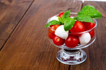 Wall Mural - Caprese salad in glass. Studio Photo.