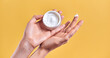 © Olena Apetroaiei - Skin care product. Close-up of women's hands holding a face cream jar. Beauty and spa product.