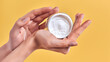 © Olena Apetroaiei - Skin care product. Close-up of women's hands holding a face cream jar. Beauty and spa product.