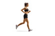 Full length profile shot of a female athlete wearing crop top and shorts and running