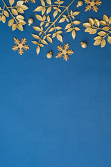 Wall Mural - Christmas holiday composition. Flat lay frame with christmas golden decorations on a blue background