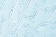 © svetolk - Cosmetic gel or beauty jelly serum texture background. Transparent skin care collagen product backdrop. Antibacterial sanitizer or liquid water moisture toner smudged smear close up photo