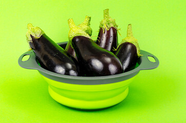 Wall Mural - Clean washed eggplant for cooking in colander. Studio Photo.