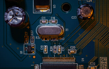 Wall Mural - A close-up macro shot of a quartz resonator for controlling a computer (CPU), a quartz clock on an electronic printed circuit board (PCB) that is part of a video card's control.