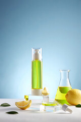 Wall Mural - Lemon extract in test tube , cosmetic jar , lemon and sliced lemon , green leaf in a blue background cosmetic template for cosmetic advertising , front view , photography experiment content 