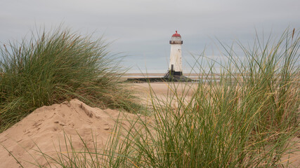 Wall Mural - beautiful sunrise landscape image of talacre beach lighthouse at surnise with dramatic sky and cloud
