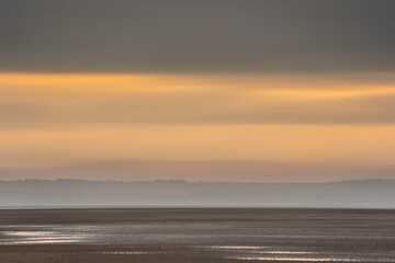 Wall Mural - beautiful sunrise landscape image of talacre beach at surnise with dramatic sky and clouds