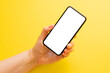 © Kaspars Grinvalds - Mobile phone with empty white screen on yellow background