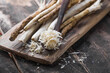 Fresh organic horseradish or Horse-radish root on wooden cutting board.