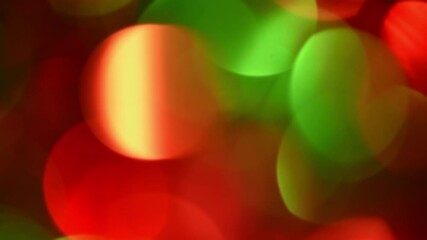 Wall Mural - Christmas Bokeh Moves From Side To Side. Green and Red round bokeh floating and shimmering from left to right and back. New Year bokeh motion on a dark backdrop. Can be used as overlay or background.