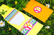 Hippie style wedding invitations lie on the grass