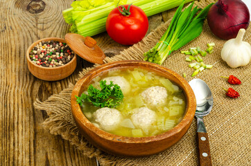 Wall Mural - Vegetable soup with meatballs, vegetables on background.