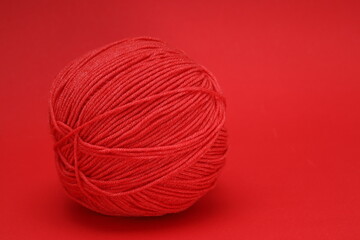 Wall Mural - red wool ball on red background