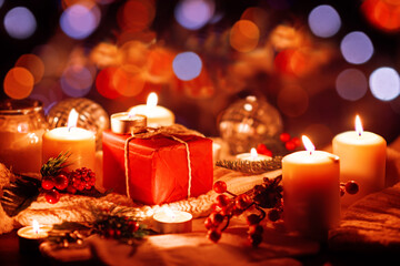 Wall Mural - Winter Christmas holidays background with candles, christmas light, toy near a window