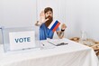 © Krakenimages.com - Caucasian man with long beard at political campaign election holding russia flag with open hand doing stop sign with serious and confident expression, defense gesture