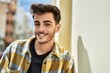© Krakenimages.com - Handsome hispanic man smiling happy and confident at the city