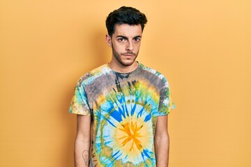 Wall Mural - Young hispanic man wearing casual clothes skeptic and nervous, frowning upset because of problem. negative person.