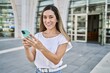 © Krakenimages.com - Young hispanic woman smiling confident using smartphone at street