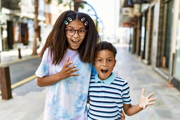 Poster - African american family of bother and sister standing at the street celebrating victory with happy smile and winner expression with raised hands