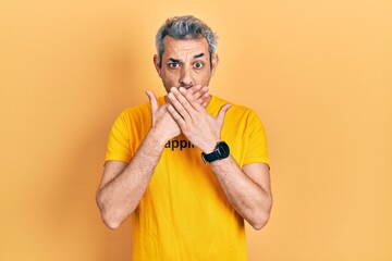 Poster - Handsome middle age man with grey hair wearing t shirt with happiness word message shocked covering mouth with hands for mistake. secret concept.