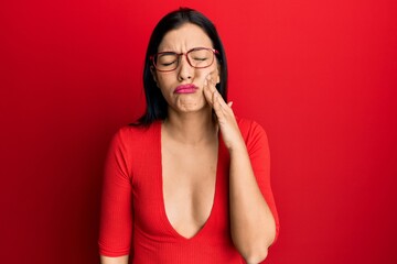 Sticker - Young latin woman wearing casual clothes and glasses touching mouth with hand with painful expression because of toothache or dental illness on teeth. dentist