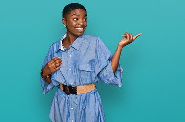 Poster - Young african american woman wearing casual clothes smiling happy pointing with hand and finger to the side