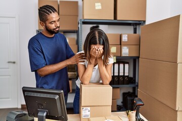 Canvas Print - Man and woman business partners worry for problem with hands on face at storehouse