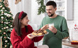 © puhimec - Happy husband and wife with Christmas cookies and milk in the kitchen.