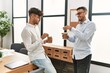 © Krakenimages.com - Two hispanic men business workers drinking coffee working at office