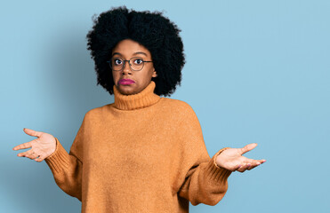 Canvas Print - Young african american woman wearing casual clothes clueless and confused expression with arms and hands raised. doubt concept.