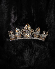 Wall Mural - beautiful silver crown with a yellow stone for a beauty pageant on a black background, accessory headdress, close-up
