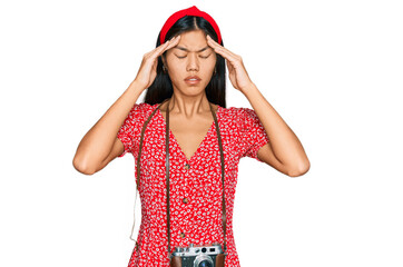 Sticker - Beautiful young asian woman wearing dress and vintage camera suffering from headache desperate and stressed because pain and migraine. hands on head.