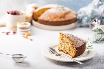 Wall Mural - Traditional Christmas cake pudding with fruits and nuts with Christmas decorations, light background