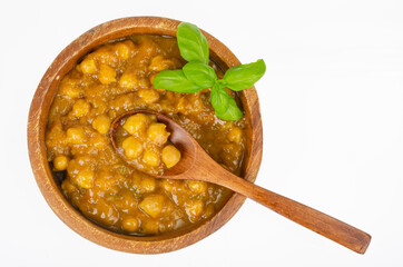 Wall Mural - Chickpeas with curry sauce in wooden bowl. Studio Photo