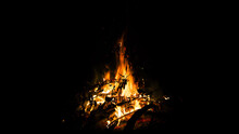 Big Beautiful Bonfire On Black Background. Real Fire Flames. Burning. Ignited. Night Campfire. Orange Color. Nature Landscape. Outdoors Recreation. Autumn Garden Cleaning. Hot. Close-up Side View