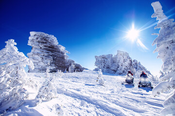 polar arctic snow mountains with sun light. concept travel tourist group snowmobile tour in frozen f