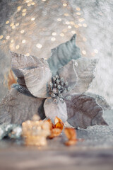 Wall Mural - Christmas poinsettia flower and blurred light beautiful background with yellow bokeh. Toned image. Dry flowers, mirror balls.