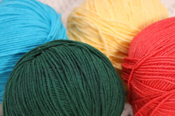 Poster - four balls of wool on a knitted white napkin