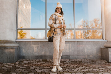 young smiling woman walking in street in winter