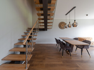 Modern interior of private house. Living room with table and chairs.