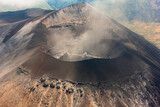 Fototapeta  - Stunning view into a smoking volcano caldera in the Serengeti National Park, near Arusha, Tanzania