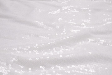  White sequin background. White shiny sequin fabric.