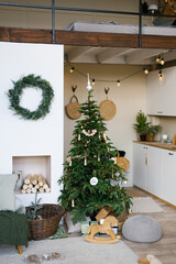 stylish christmas decor in a scandinavian country house in beige tones. fireplace and christmas tree
