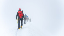 Group Of Glacier Mountaineers On A Rope