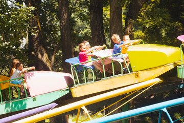 Wall Mural - The confused kids ride a roller coasters for the first time