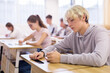 © JackF - Portrait of diligent teenager schoolboy sitting in class working with classmates