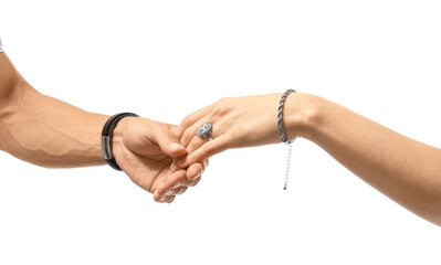 Man holding woman's hand with silver jewelry on white background