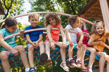 Wall Mural - The cute kids are resting in the playground in summer