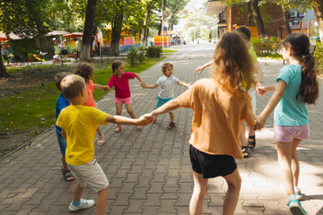 Wall Mural - The group of little friends actively resting in the park